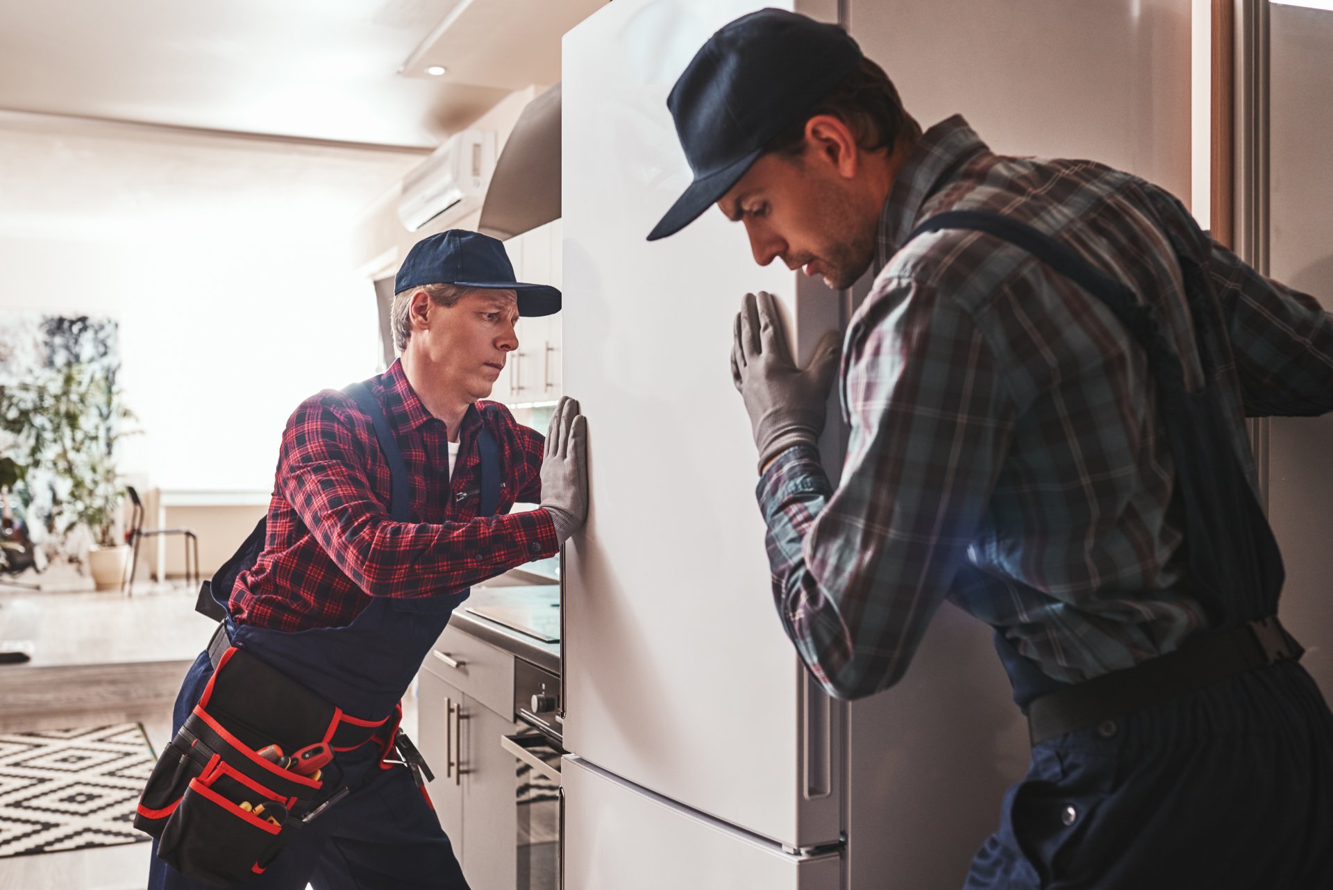 Person looking frustrated covering ears next to squeaking dryer making loud noises
